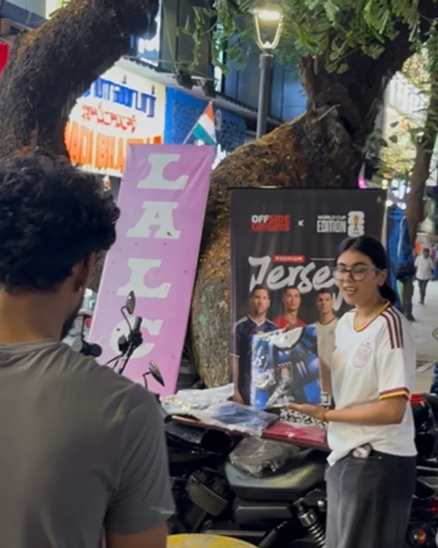 A conversation at an outdoor sales stall