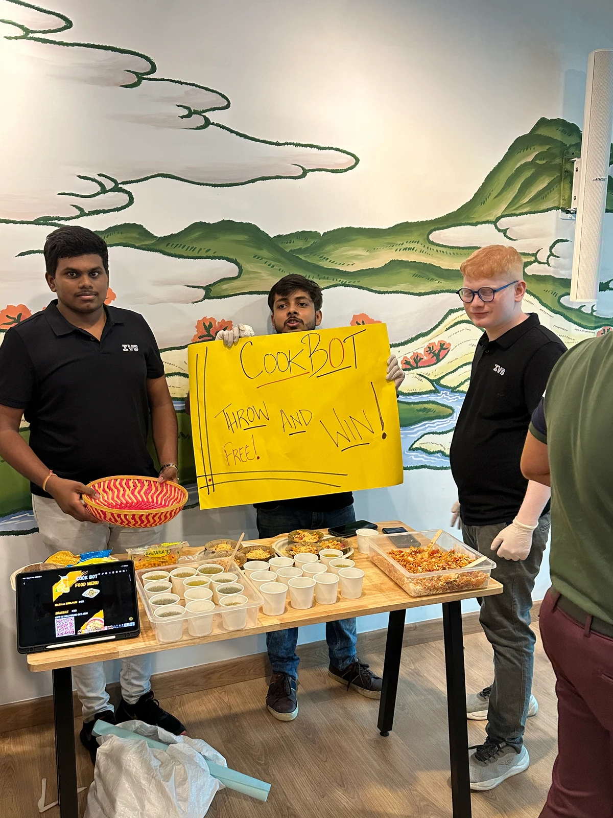 Students presenting products to visitors at an indoor sales stall
